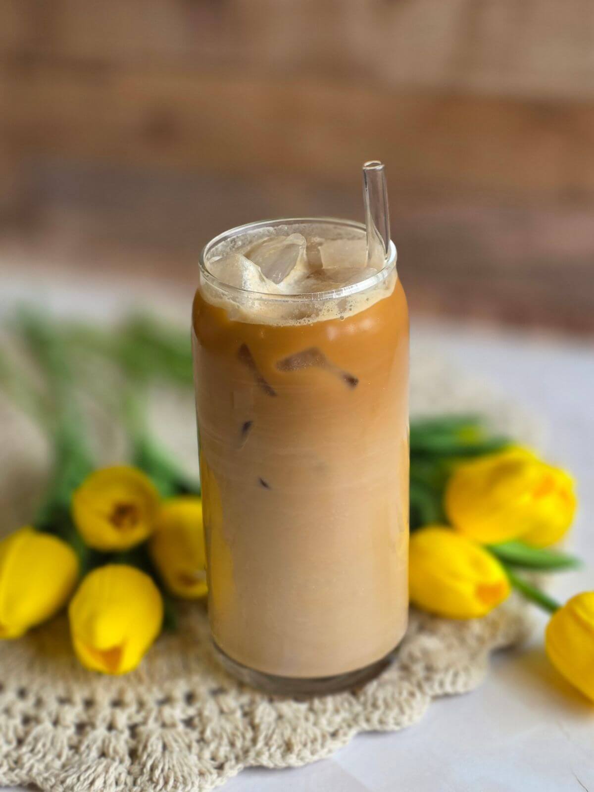 Homemade maple iced coffee stirred together with espresso, milk, cream, maple syrup and ice.