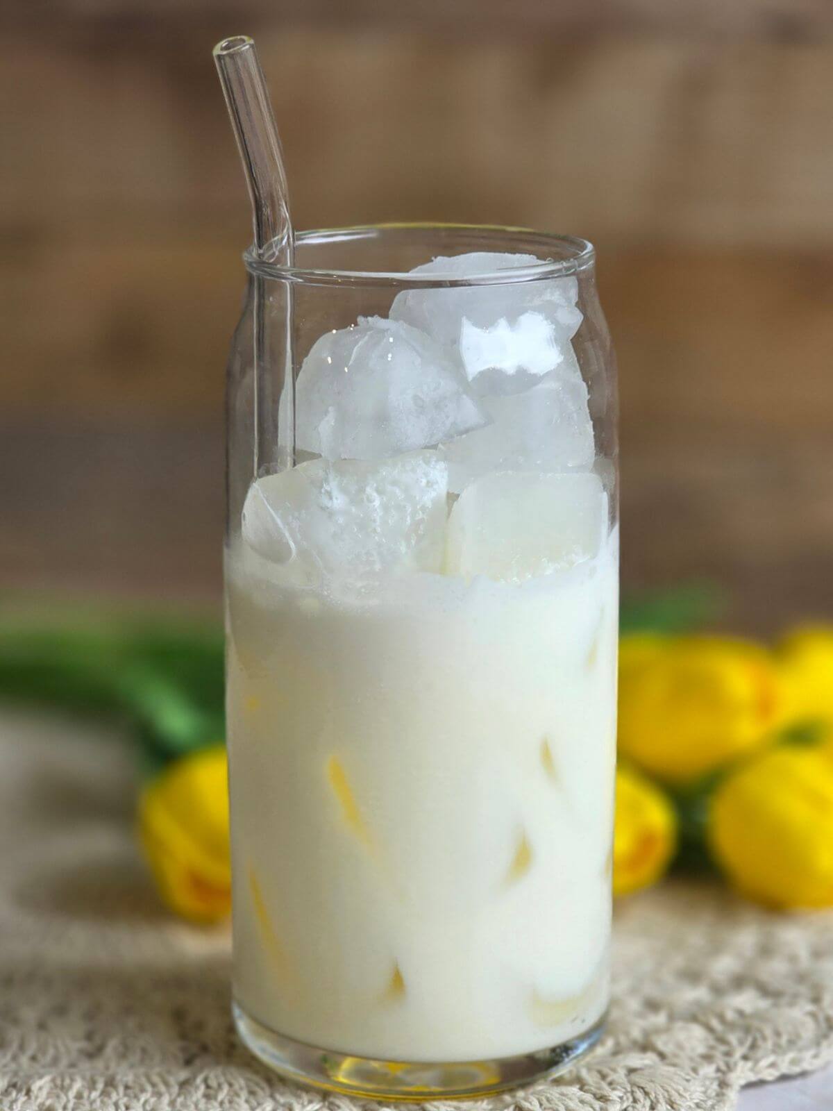 Tall glass filled with cold milk, heavy cream and ice before adding espresso.