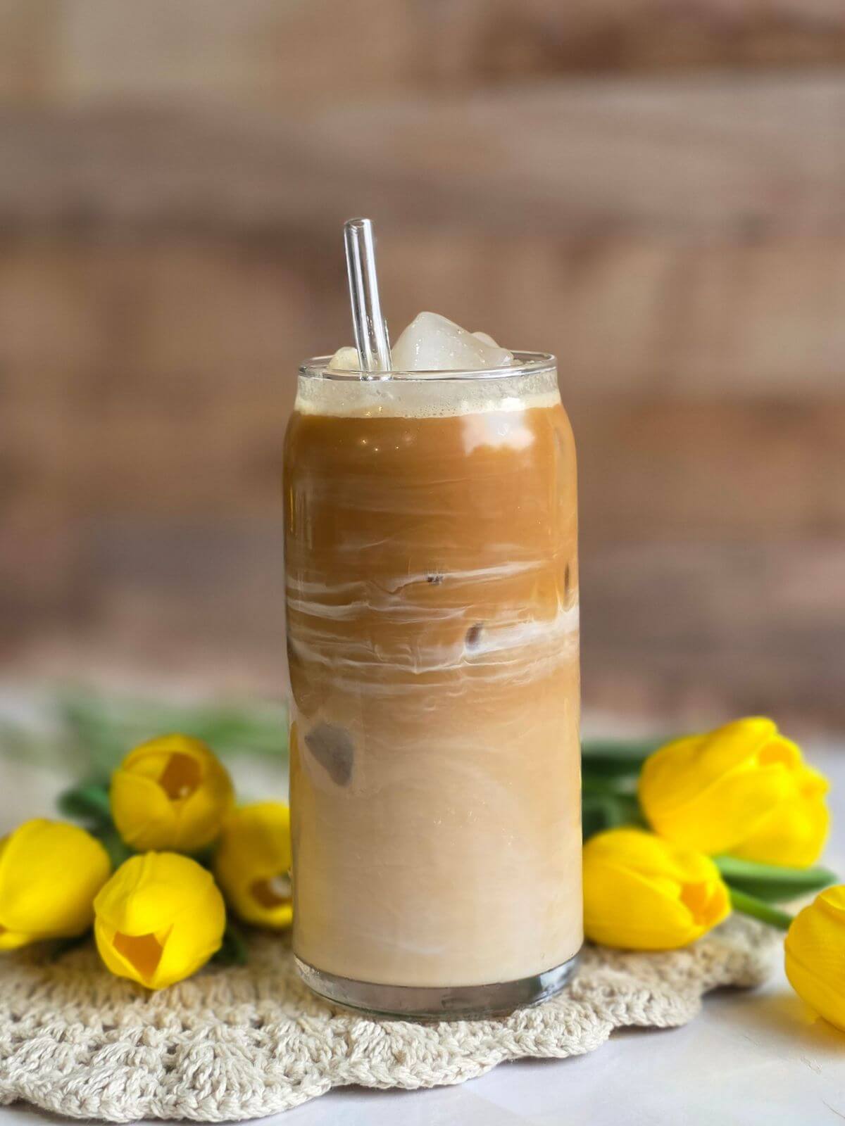 Creamy maple iced coffee with swirls of espresso and milk served over ice.