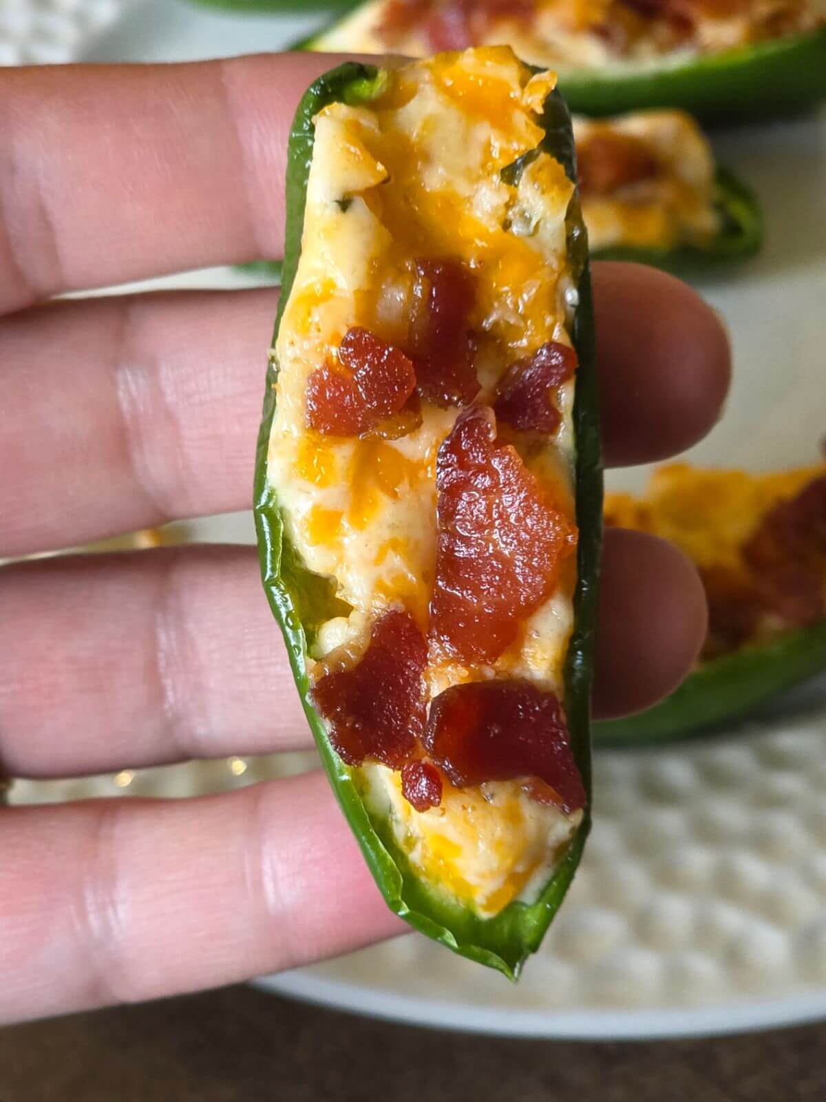 Cream cheese jalapeño popper with melted cheddar and bacon filling.