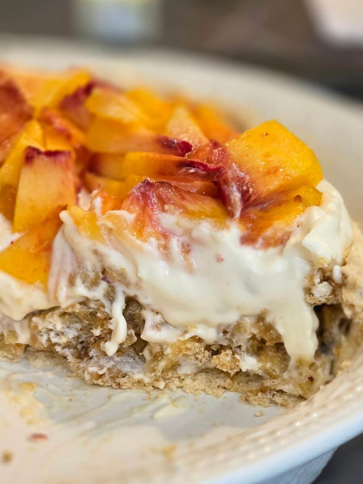 Fresh peach pie with cream cheese whipped cream and soda cracker crust.