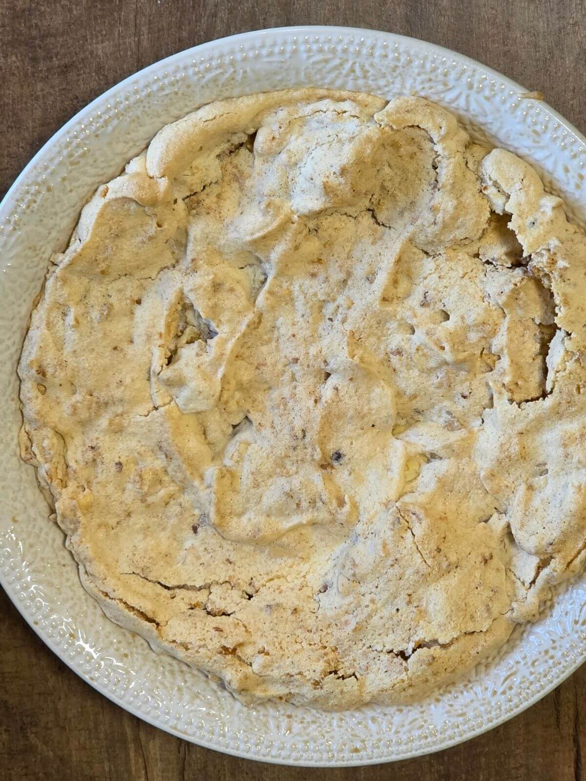 Baked soda cracker walnut crust cooling in a pie plate.