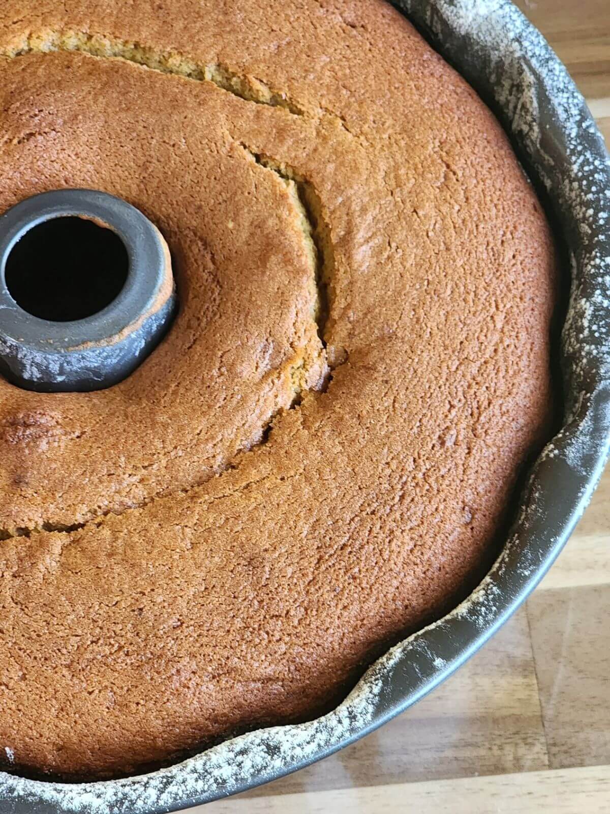 Freshly baked pumpkin spice Bundt cake cooling in a floured Bundt pan.