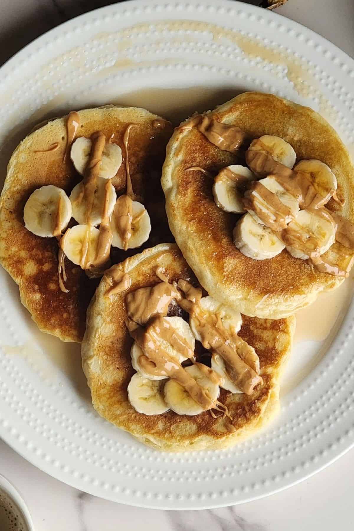 Sourdough pancakes with banana, peanut butter and maple syrup.
