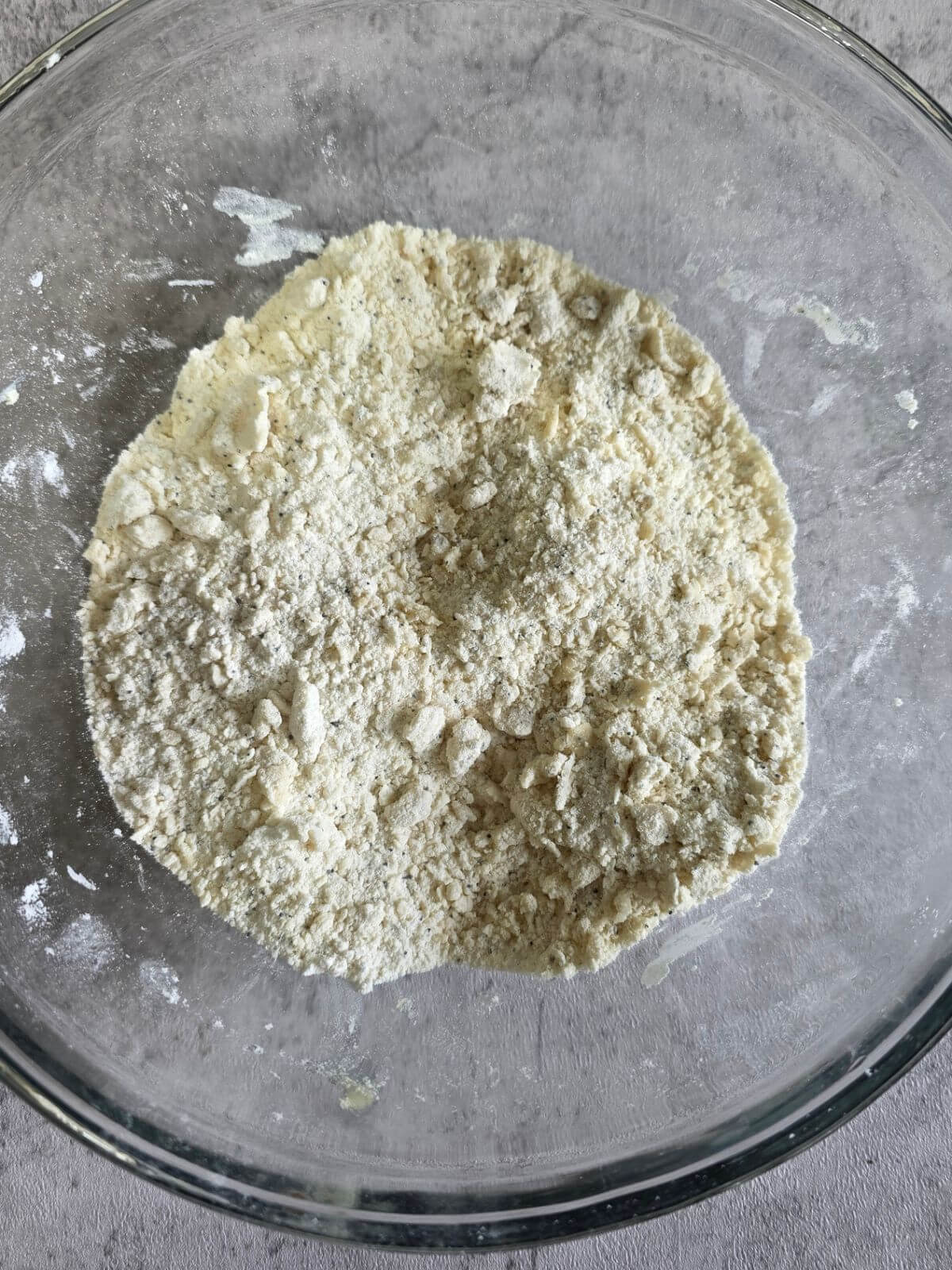 Cold butter cut into the flour mixture for almond poppy seed scones.