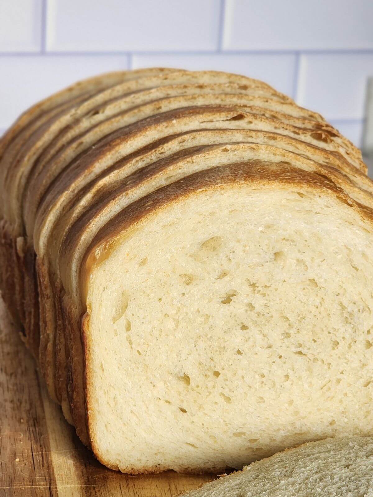 A loaf of sourdough sandwich bread sliced.