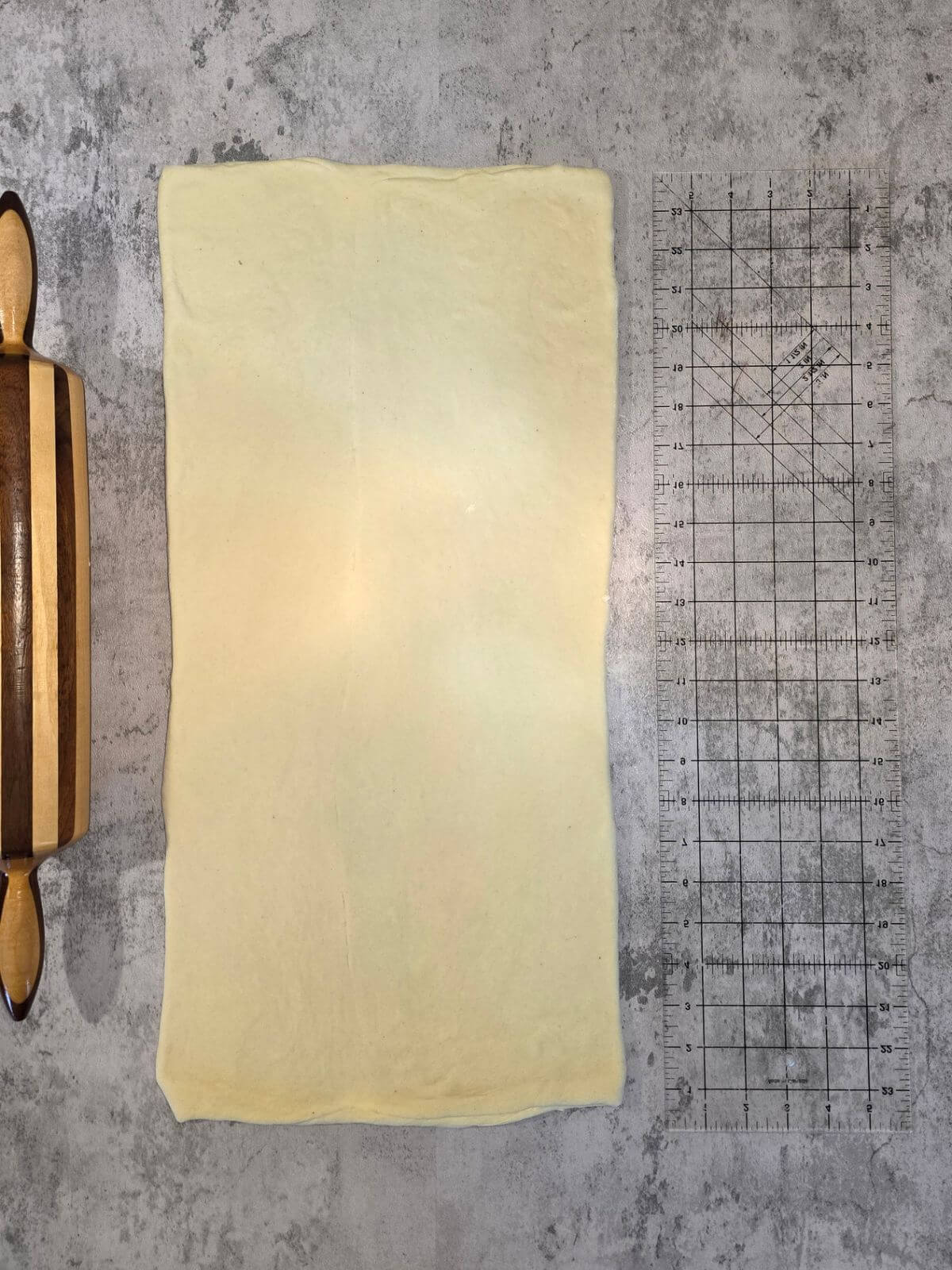 Chilled croissant dough rolled into a thin rectangle before cutting.