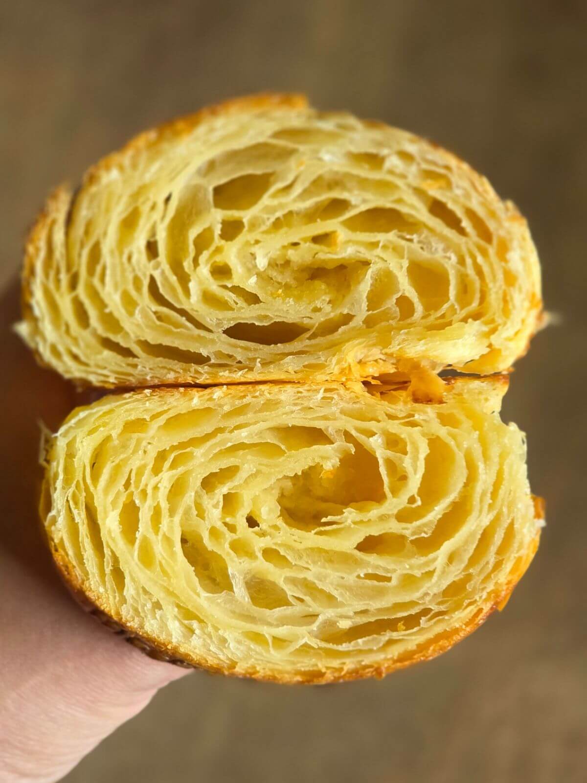 Sliced sourdough croissant showing the layered interior crumb.