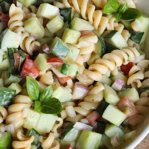cucumber pasta salad with balsamic dressing in a white bowl