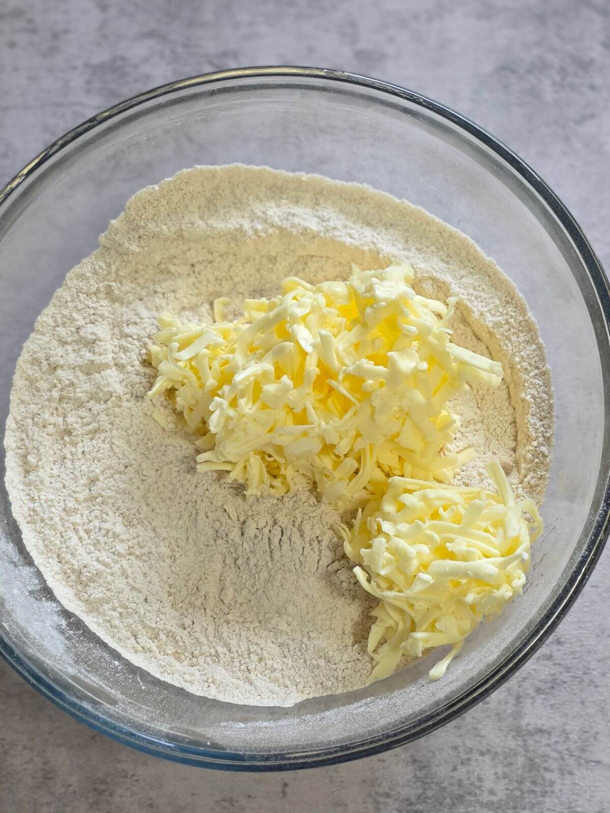 Cold grated butter added to the dry ingredients for sourdough scones.