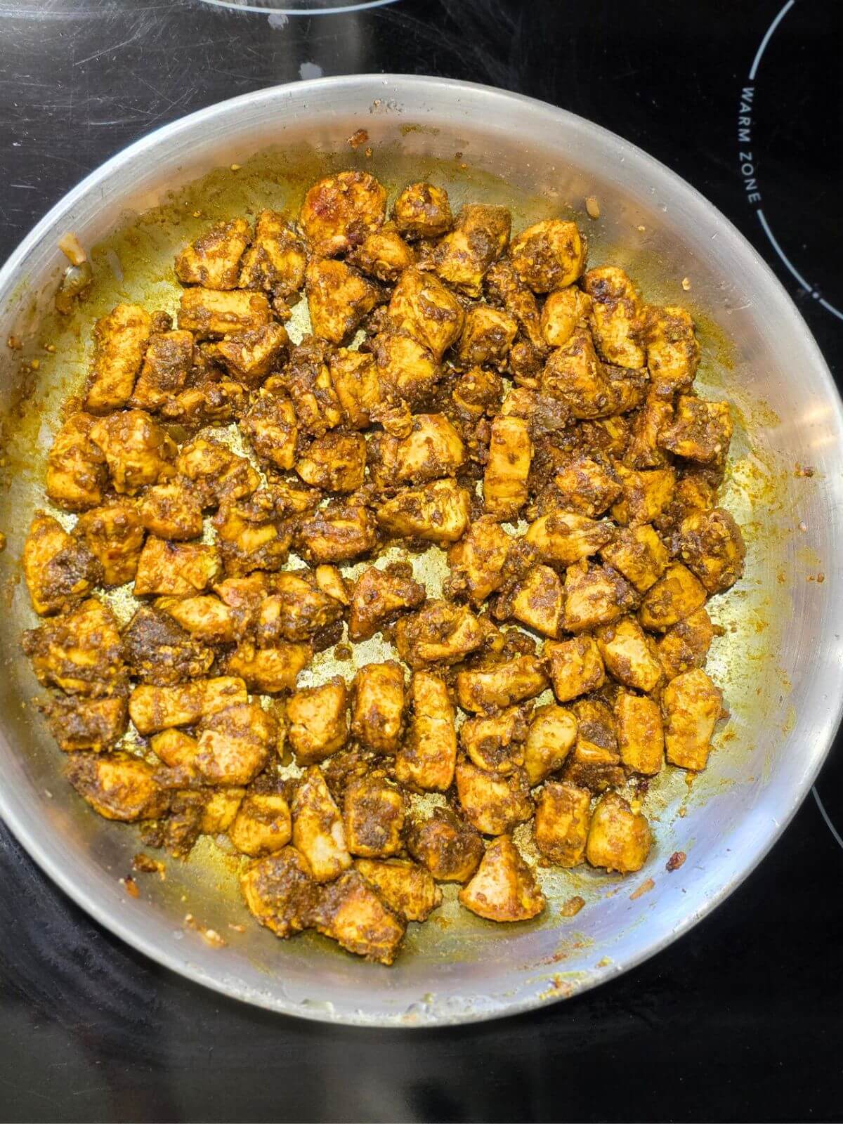 Chicken coated in spices for butter chicken.