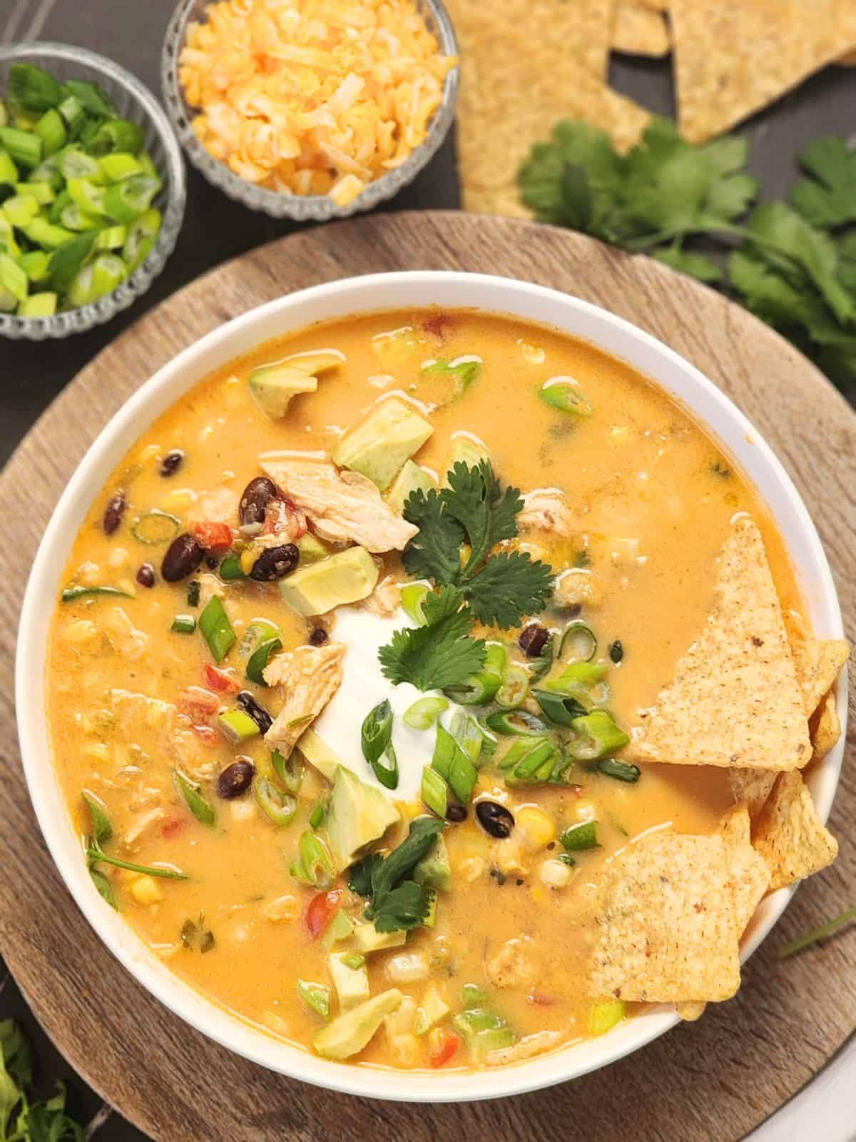 Melted cheddar cheese and shredded chicken swirled through a steaming bowl of tortilla soup.