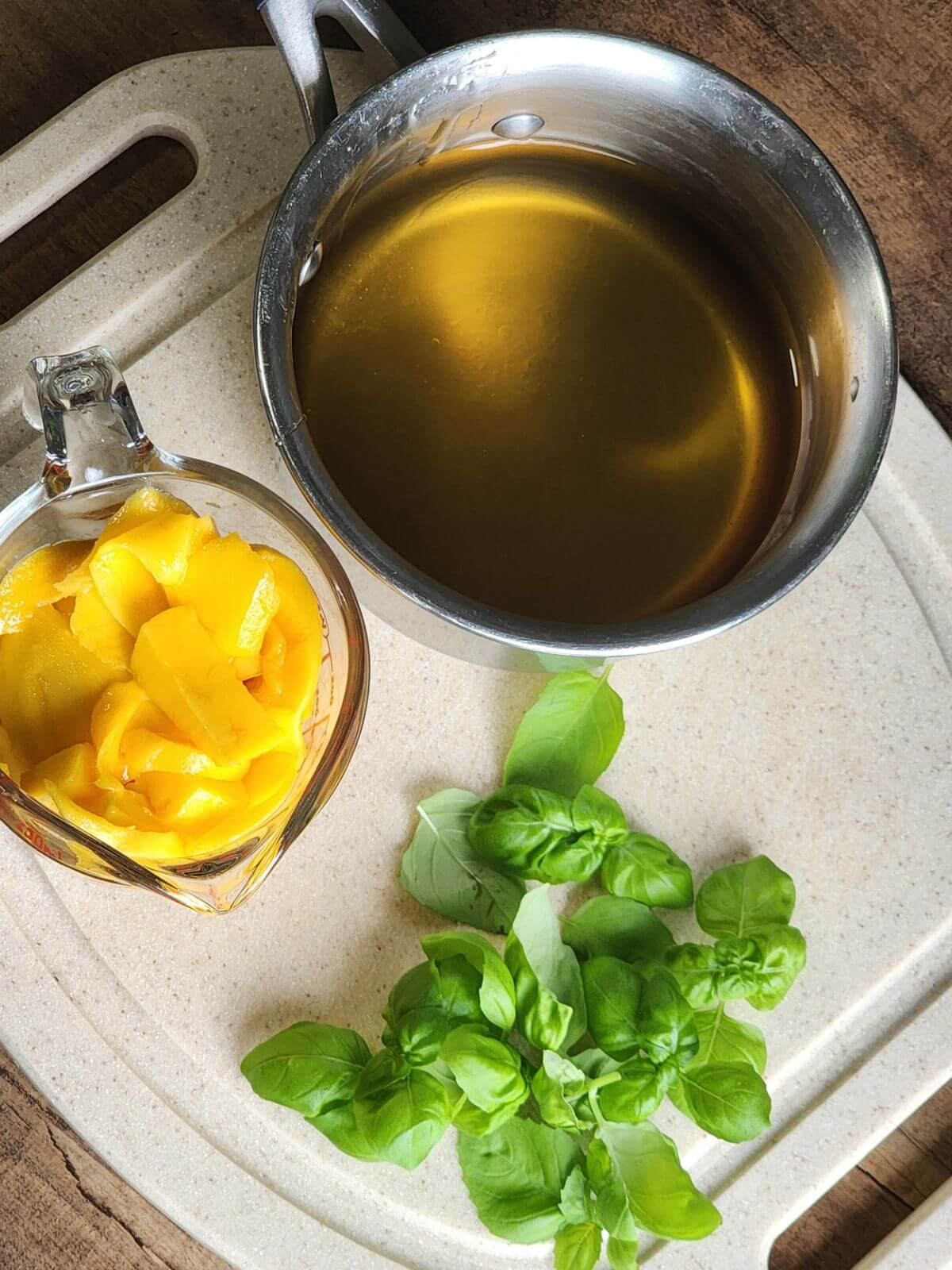 Fresh mangoes, basil, honey, and sparkling water for homemade mango syrup.