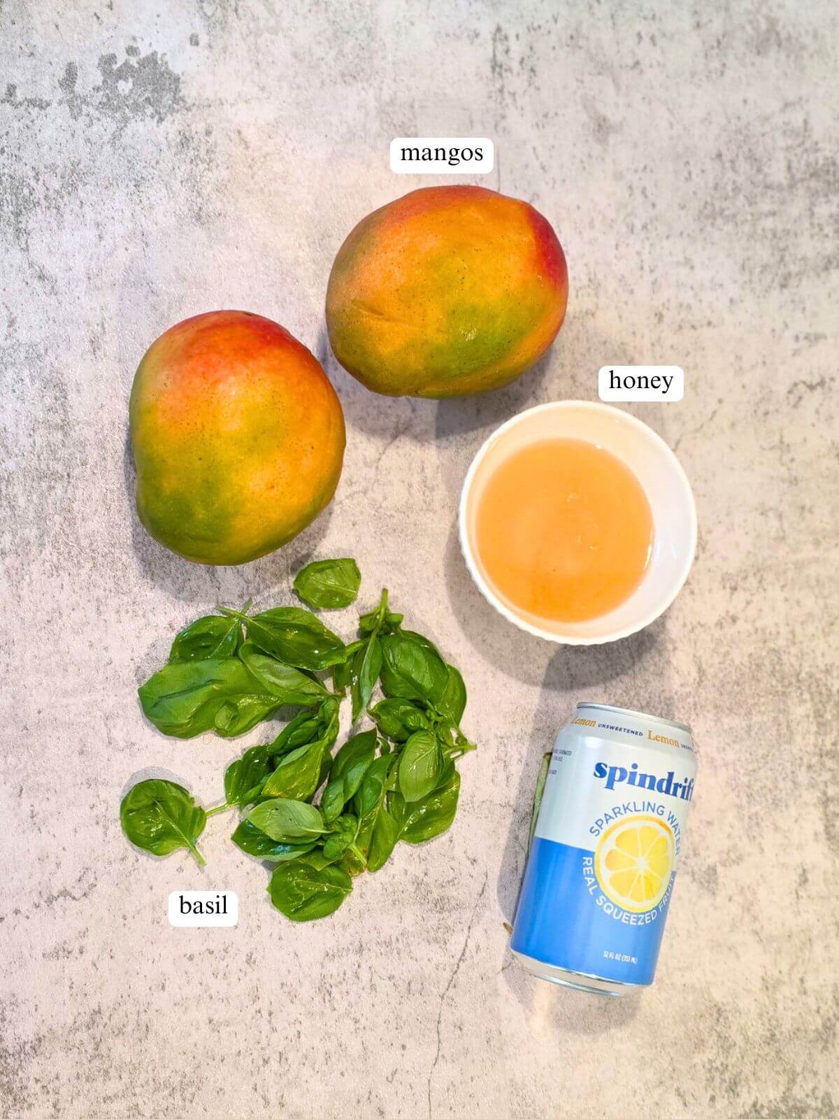 Fresh mangoes, basil, honey, and sparkling water for homemade mango syrup.