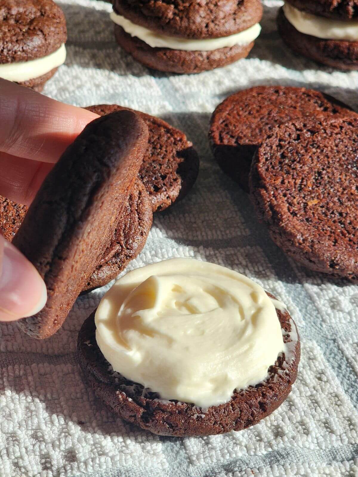 Homemade sourdough Oreo cookie with chocolate cookie shells and cream cheese filling.