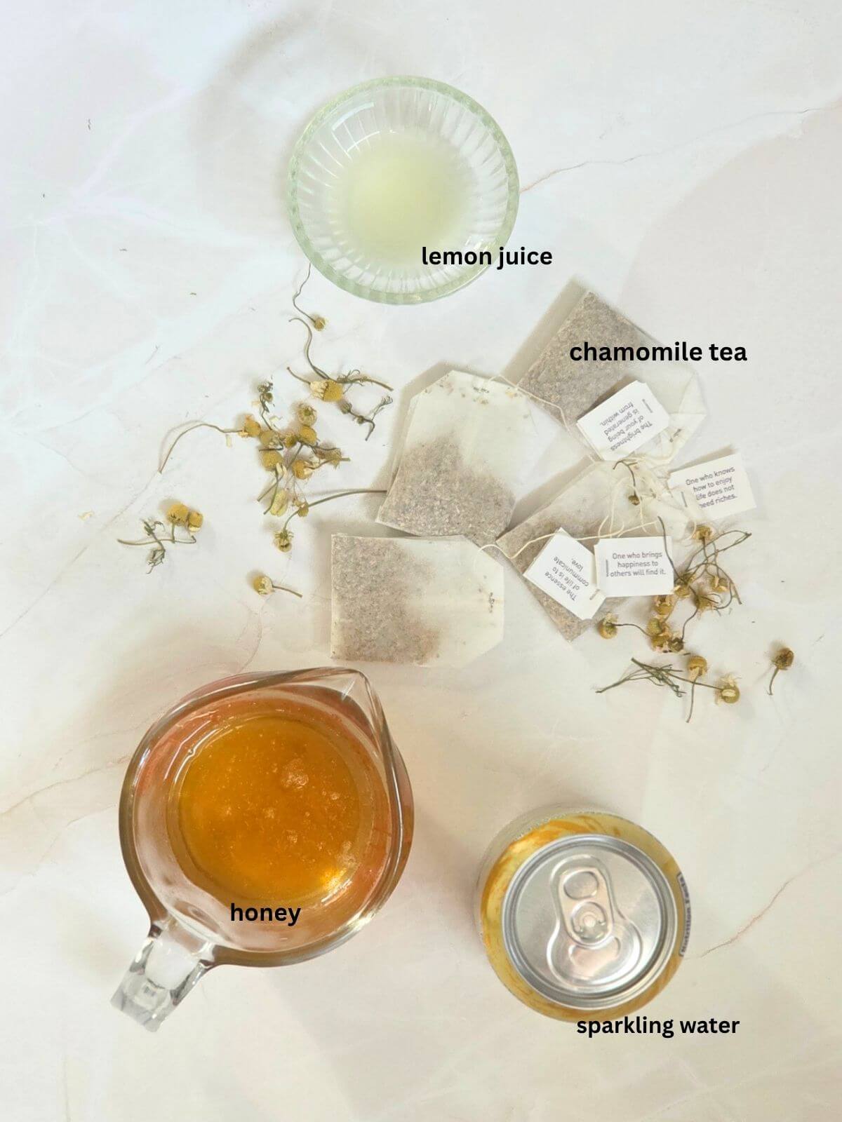 Sparkling Chamomile Tea Mocktail ingredients laid out on a flat surface.