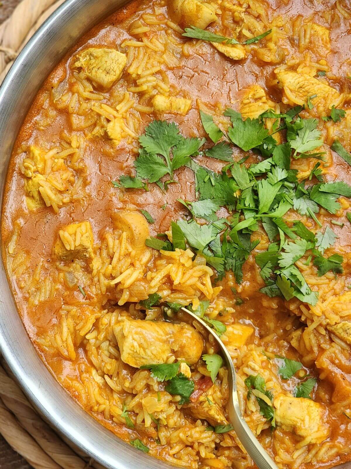 One pot chicken tikka masala rice with tender chicken, creamy tomato sauce, and fresh cilantro.