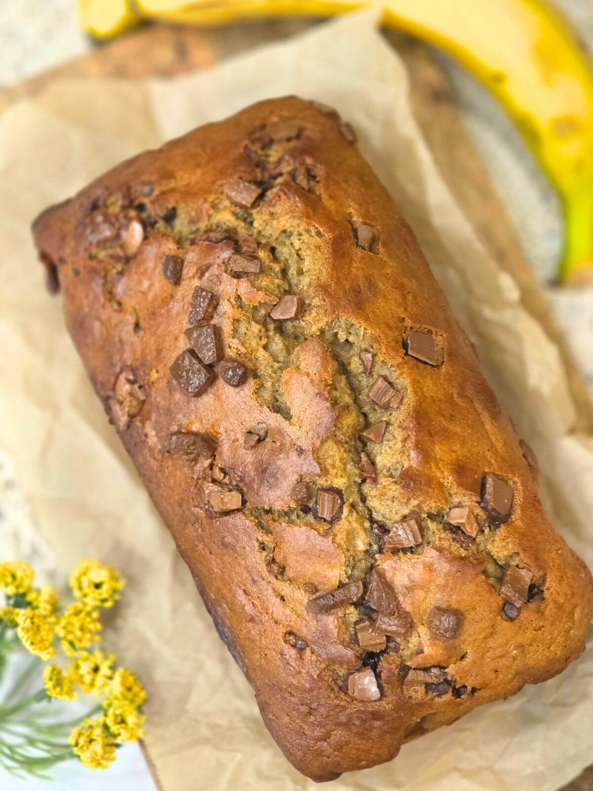 Freshly baked sourdough discard banana bread loaf with chocolate chips.