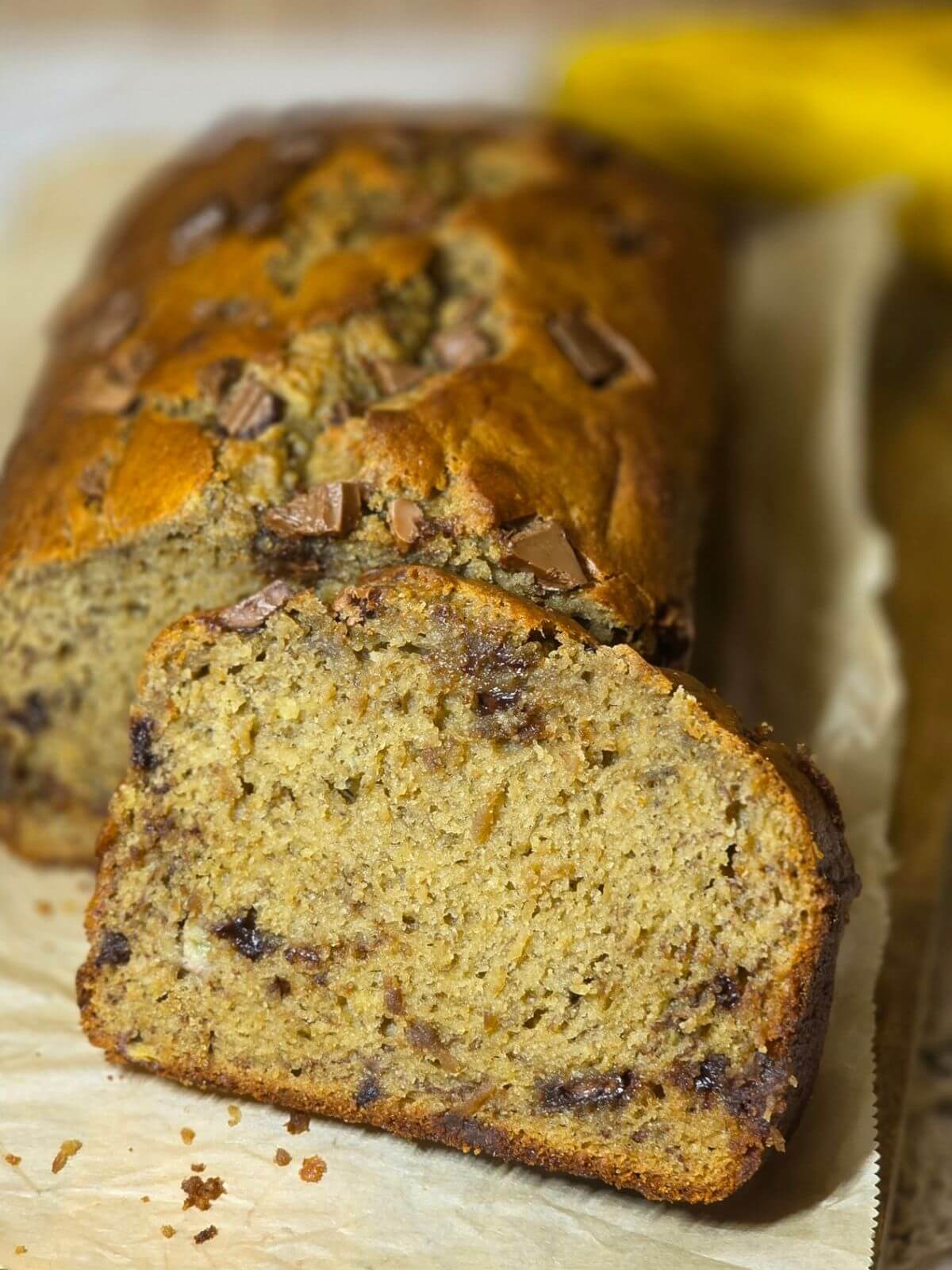 Close up slice of sourdough chocolate chip banana bread with a soft, tender crumb.