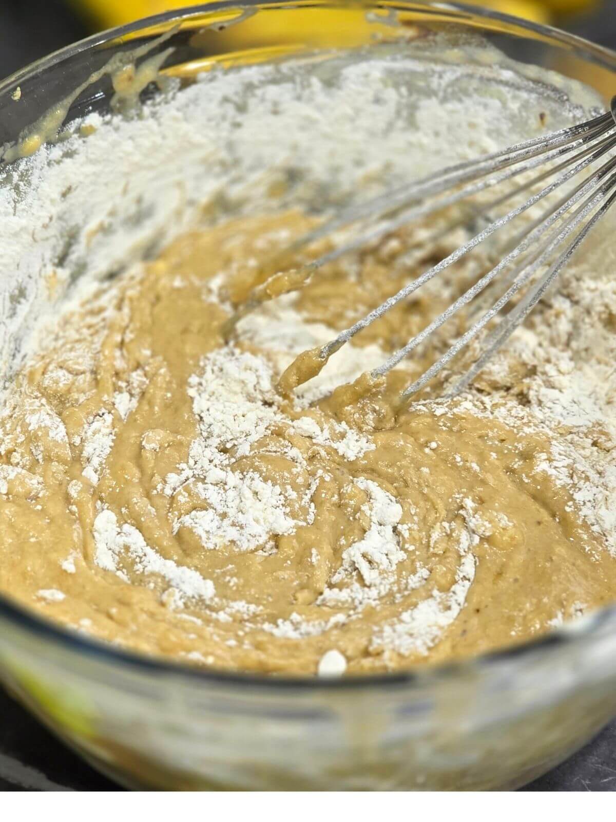 Flour being mixed into sourdough discard banana bread batter.
