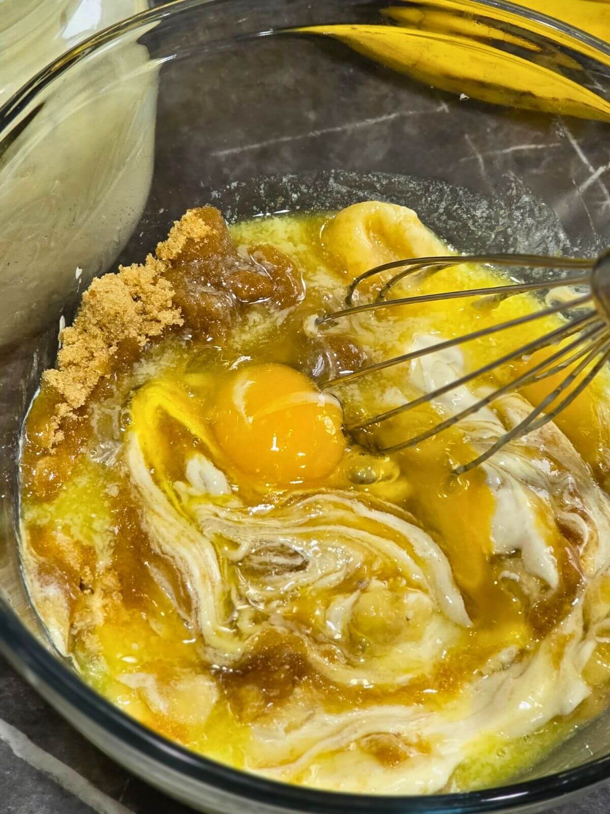 Sourdough discard banana bread wet ingredients with mashed bananas, eggs, brown sugar, butter, and starter.